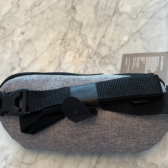 Therabody crossbody bag - filled with amazing travel products. - Picture 3 of 4